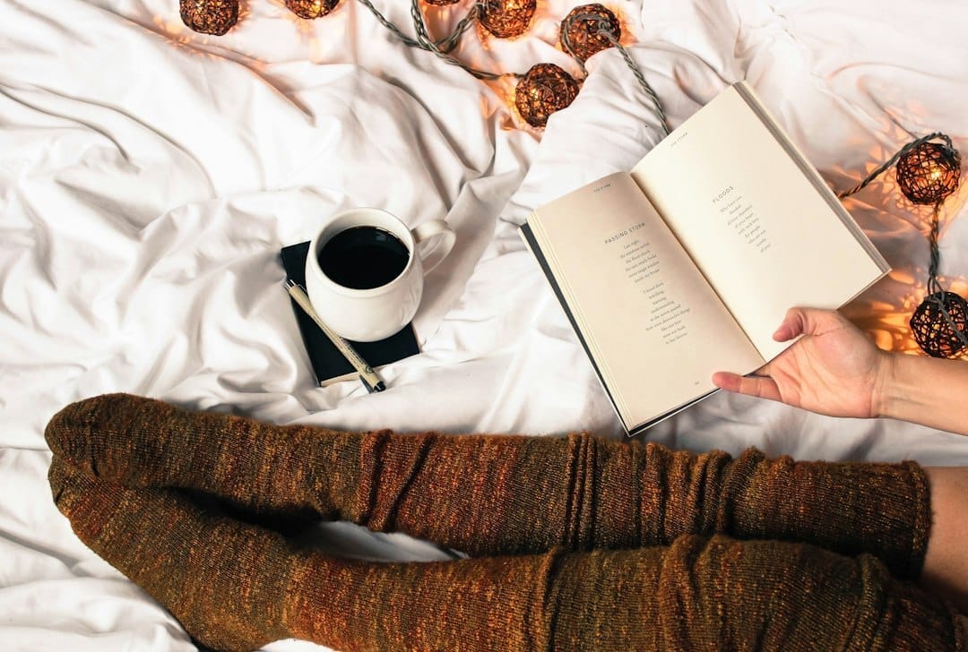 mug of black coffee beside person&#39;s feet wearing brown stockigns