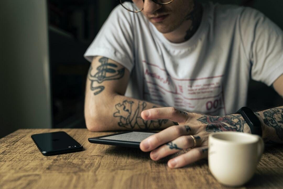 man in white crew neck t-shirt wearing black framed eyeglasses